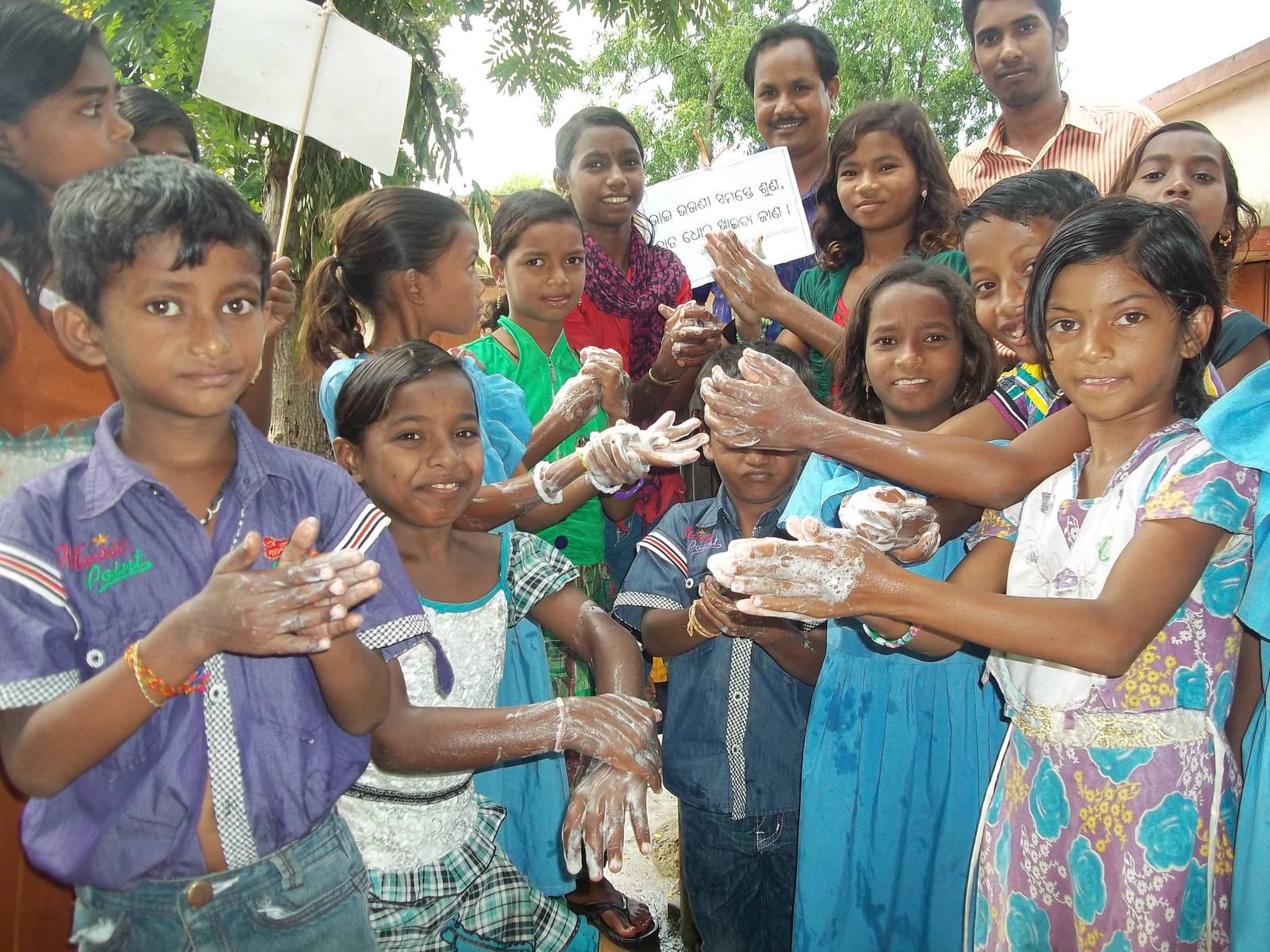 Children practicing handwashing during an RWI hygiene awareness program in Odisha